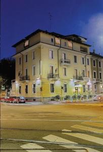 a large yellow building on the side of a street at Hotel Florence Milano in Milan