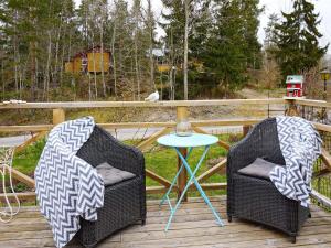 two chairs and a table on a deck at 5 person holiday home in FLEN in Flen