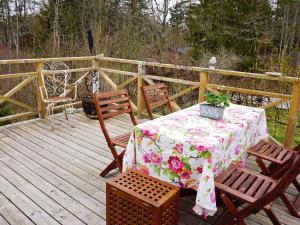 une terrasse en bois avec une table et des chaises. dans l'établissement 5 person holiday home in FLEN, à Flen