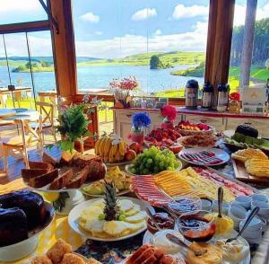 a table filled with lots of different types of food at Tedesco Eco Park in São Francisco de Paula