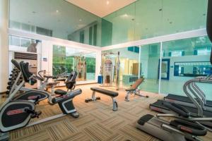 a gym with a bunch of exercise equipment in a room at Light, airy, east facing 2 bed/2 bath pool views in Hua Hin