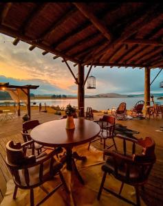 a table and chairs on a patio with a view of the ocean at Tedesco Eco Park in São Francisco de Paula