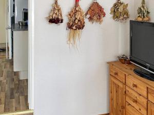 a kitchen with a wall with dried plants on it at 6 person holiday home in N SSJ in Nässjö