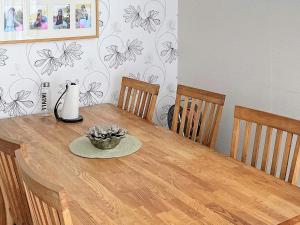 a dining room table with a vase on top of it at 6 person holiday home in N SSJ in Nässjö