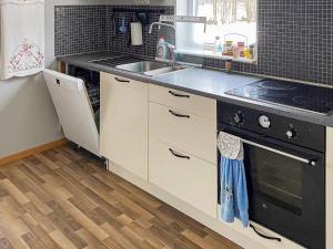 a kitchen with a sink and a stove at 6 person holiday home in N SSJ in Nässjö