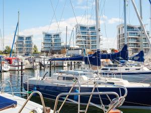 a group of boats docked in a marina with tall buildings at Apartment Wendtorf X in Wendtorf