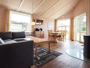 a living room with a couch and a table at Two-Bedroom Holiday home in Grömitz 2 in Grömitz