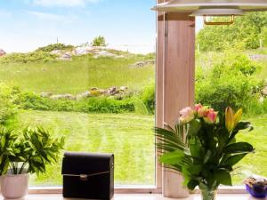 a window with a view of a field of grass at 4 person holiday home in FALKENBERG in Falkenberg