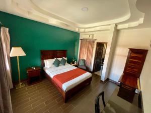 En eller flere senge i et værelse på Hotel Wilson Anexo