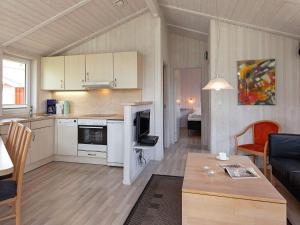 a kitchen and living room with a couch and a table at Two-Bedroom Holiday home in Grömitz 20 in Grömitz