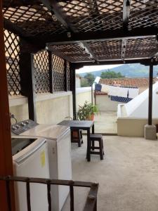 a patio with a table and a picnic table on a roof at La casita de Angie in Antigua Guatemala