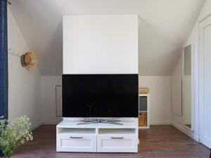 a living room with a tv on a white cabinet at Holiday home RIMBO II in Rimbo