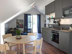 a kitchen and dining room with a table and chairs at Holiday home RIMBO II in Rimbo