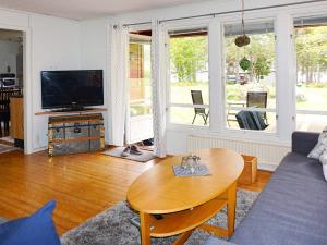 a living room with a table and a tv at 6 person holiday home in Mönsterås-By Traum in Mönsterås