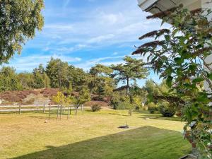 un parque con un parque infantil con árboles y césped en 5 person holiday home in N sund, en Nösund