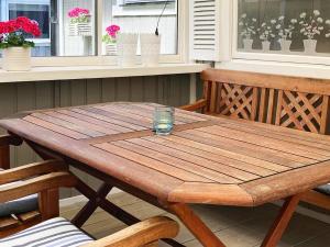 a wooden table with a glass on top of it at 6 person holiday home in L derup in Löderup