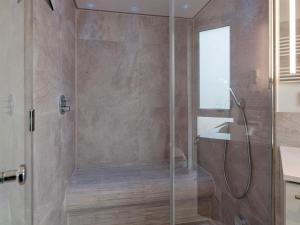 a shower with a glass door in a bathroom at Exklusive Meerblickwohnung in 1 Reihe in Wendtorf