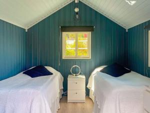a green room with two beds and a window at Holiday home KUNGSHAMN XI in Kungshamn