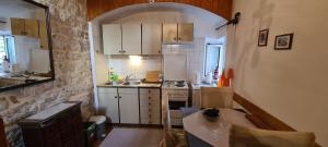 a small kitchen with a sink and a stove at House Old town stone house in Stari Grad