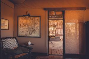a room with a map on the wall next to a door at Gmundner Lodge in Windhoek