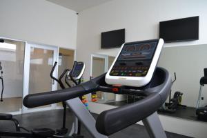 a cell phone sitting on top of a gym treadmill at Hangar Inn Guadalajara Aeropuerto in Guadalajara