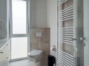 a bathroom with a toilet and a window at Luxusurlaub direkt an der Ostsee in Wendtorf +32 photos