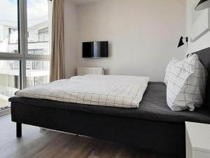 a bedroom with a bed with a television on the wall at Luxusurlaub direkt an der Ostsee in Wendtorf