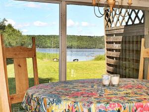 d'une table avec vue sur le lac depuis une fenêtre. dans l'établissement One-Bedroom Holiday home in Lerdala 1, à Lerdala