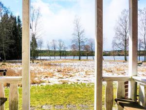 a view of a snow covered field from a porch at 8 person holiday home in LJUNG in Ljung