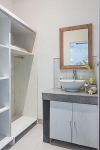 a bathroom with a sink and a mirror at Villa Mali Legian in Legian