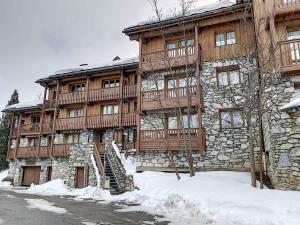 a large wooden building with snow on the ground at Appartement Val-d'Isère, 2 pièces, 2 personnes - FR-1-518-130 in Val-d'Isère