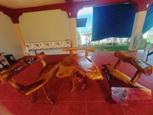 a wooden table and chairs in a room at The Beach Villa by M in Manguisoc