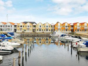 a group of boats docked in a marina with buildings at Holiday home Rudkøbing XVII in Rudkøbing