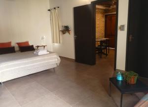 a bedroom with a bed and a table and a dining room at Violeta Roga in Asuncion