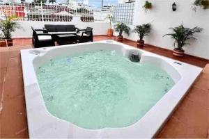 a jacuzzi tub in the middle of a patio at 4br LUXURY ROOFTOP oldcity AC jacuzzi hottub wifi in Cartagena de Indias