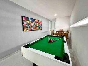 a pool table in a living room with a painting at 4br LUXURY ROOFTOP oldcity AC jacuzzi hottub wifi in Cartagena de Indias
