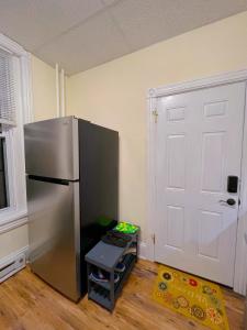 a kitchen with a stainless steel refrigerator in a room at Home sweet home in the heart of Wilmington. in Wilmington