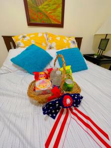 a basket of food on a bed with an american flag at Home sweet home in the heart of Wilmington. in Wilmington