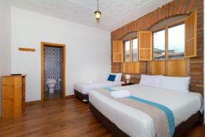 Кровать или кровати в номере San Rocke House Hotel +33 фотографии
