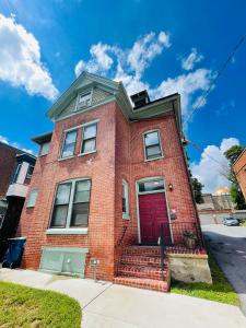 a red brick house with a red door at Home sweet home in the heart of Wilmington. in Wilmington