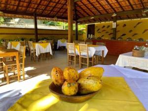 a bowl of fruit on a table in a restaurant at Pousada Refugium in Itacaré