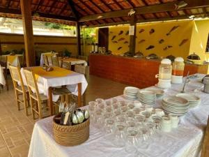 a table with plates and wine glasses on it at Pousada Refugium in Itacaré +17 photos