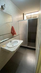 een badkamer met een wastafel en een spiegel bij La Posada de Pepe in Piura