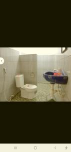 a bathroom with a toilet and a sink at BUKIT GARDEN in Mataram