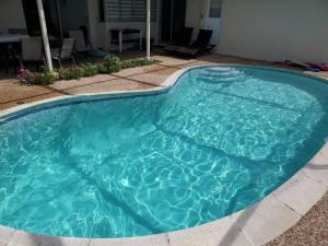 una piscina con acqua turchese di Beautiful & Peaceful 4 Bedroom Home With a Pool a Sunrise