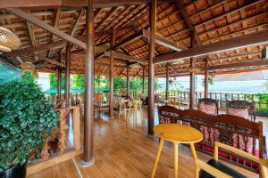 a restaurant with tables and chairs and a wooden ceiling at Alley Garden Homestay Hoi An in Hoi An