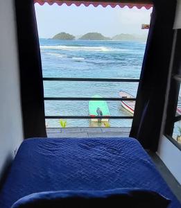 a view of the ocean from a bedroom window at Casa Bajo Congo in Colón