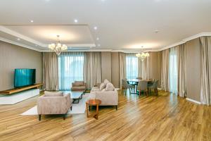 a living room with a couch and a table at İsr Baku Hotel apartment with a pool in Baku