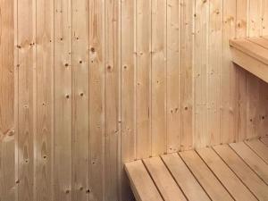 a wooden wall with a wooden bench in a room at 10 person holiday home in SÄLEN in Stöten +15 photos