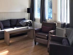 a living room with a couch and a chair at 10 person holiday home in S LEN in Stöten +17 photos